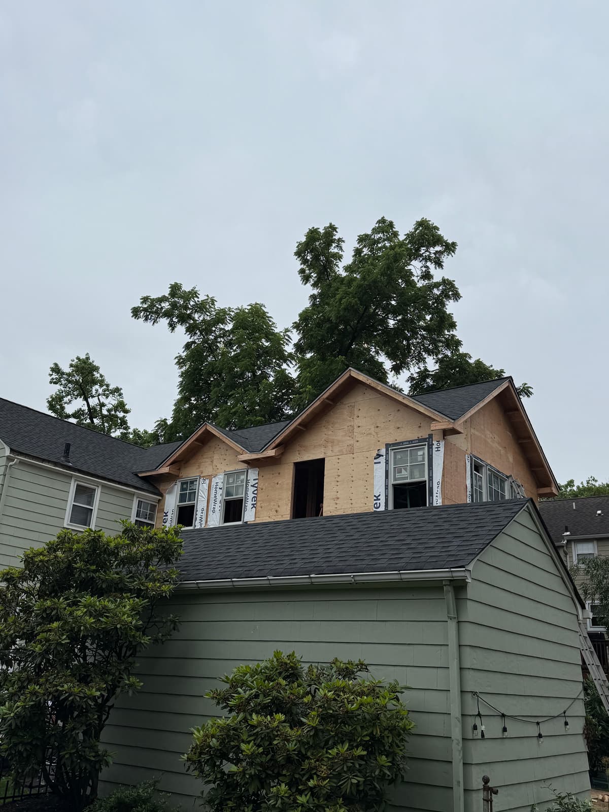 New home construction with roof installation in progress