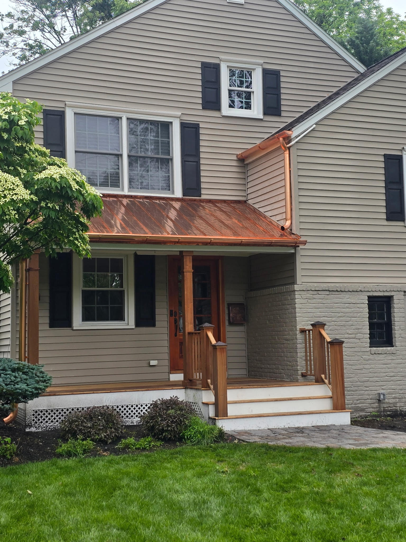 Beautiful home with copper porch roof and professional landscaping